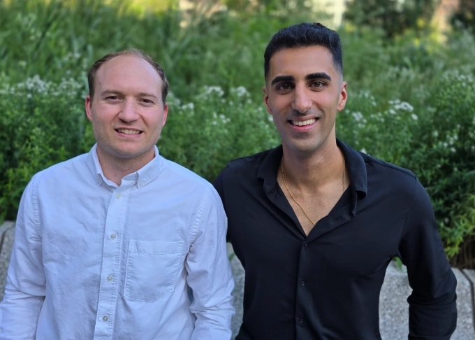 JuiceMind co-founders Ryan Dehmoubed and Philippe Rivard standing outdoors in front of greenery